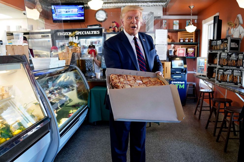 PHOTO: President Donald Trump holds a pizza during a visit to Arcaro and Genell restaurant after speaking at a campaign event, Aug. 20, 2020, in Old Forge, Pa.