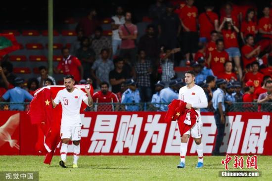 资料图：2022年世界杯亚洲区预选赛40强赛首战，中国队客战5球大胜马尔代夫队。归化球员艾克森(右)和李可赛后答谢到场的中国球迷。图片来源：视觉中国