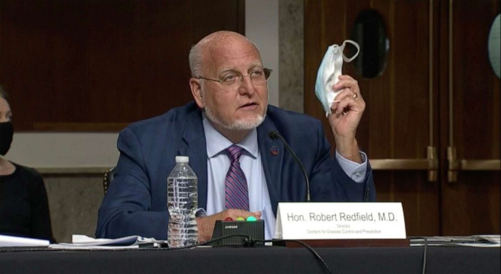 PHOTO: Centers for Disease Control and Prevention Director Dr. Robert Redfield holds up his mask as he speaks at a Senate Appropriations subcommittee hearing, Sept. 16, 2020, in Washington.