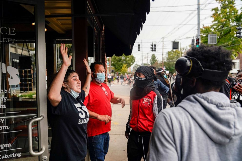 PHOTO: Business owners plead with demonstrators not to destroy their business, as people react after a decision in the criminal case against police officers involved in the death of Breonna Taylor, in Louisville, Ky., Sept. 23, 2020.