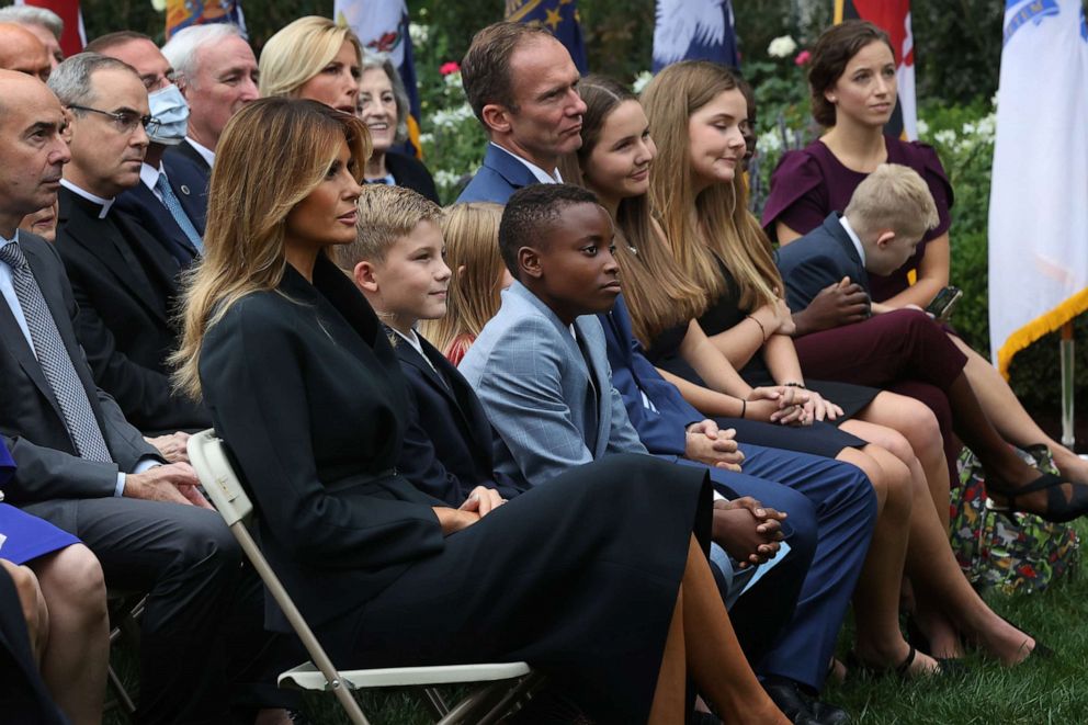 First lady Melania Trump sits next to Judge Amy Coney Barrett's family,including husband Jesse Barrett and their children, as President Donald Trump announces Barrett's nomination to the Supreme Court in the Rose Garden at the White House, Sept. 26, 2020.