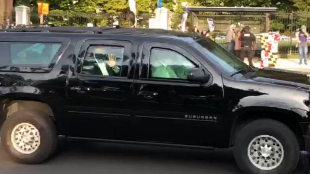PHOTO: In this still image from video footage, President Donald Trump is seen waving as his motorcade drives past supporters outside Walter Reed Medical Center, Oct. 4, 2020.