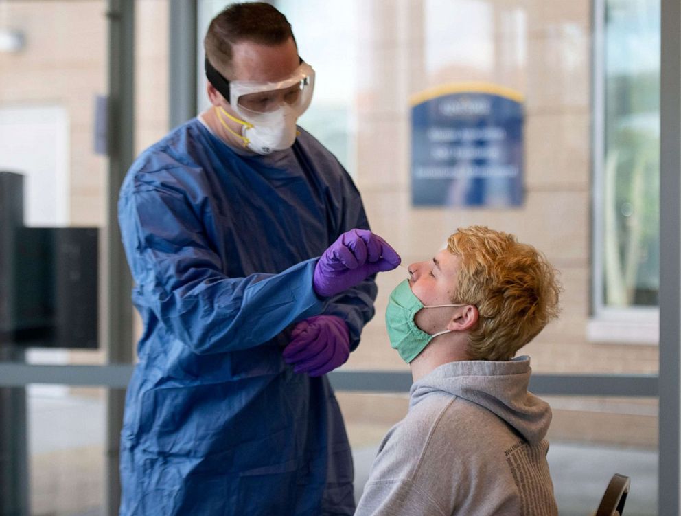 PHOTO: Andrew Robinson, a Kent State sophomore, takes a COVID test in Ohio,  Oct. 2, 2020. The Ohio Pandemic Testing Team from the Ohio National Guard, with Kent Health Department, provide free COVID-19 test at Kent State University. 