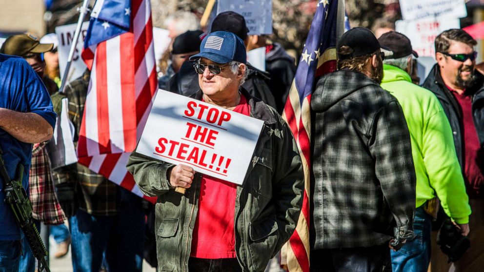 PHOTO: A protestor holds a placard saying Stop the steal during the demonstration at the Nevada state's legislative building in Carson, Nev., Feb 1, 2021.