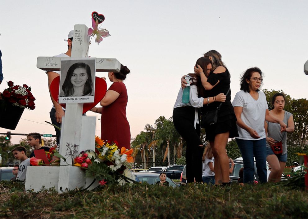 PHOTO: Magaly Newcomb, right, comforts her daughter Haley Newcomb, 14, a student at Marjory Stoneman Douglas High School, at a memorial outside the school in Parkland, Fla., Feb. 18, 2018.