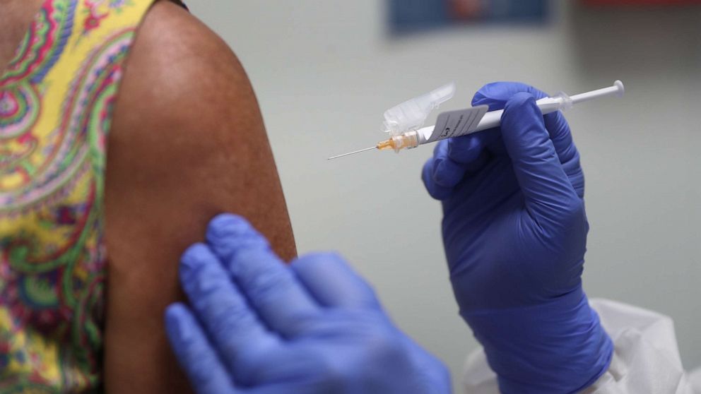 PHOTO: A woman receives a COVID-19 vaccination from nurse Jose Muniz as she takes part in a vaccine study at Research Centers of America on Aug. 7, 2020, in Hollywood, Fla.