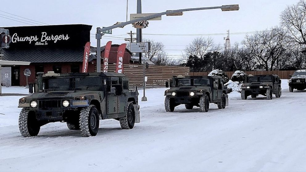 PHOTO: Military vehicles from the Texas Military Department of the Texas National Guard, tasked to transport residents to designated warming centers and other required duties, form a convoy in Abilene, Texas, Feb. 16, 2021.