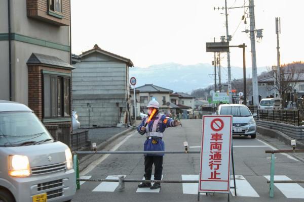 2月14日，日本福岛县桑折町一处因地震受损的房屋附近道路被封锁。新华社记者 杜潇逸 摄