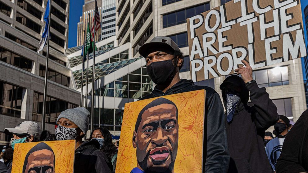 PHOTO: Demonstrators protest outside the Hennepin County Government Center before jury selection begins at the trial of former Minneapolis Police officer Derek Chauvin on March 8, 2021, in Minneapolis.