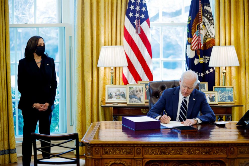 PHOTO: President Joe Biden signs the American Rescue Plan, a package of economic relief measures to respond to the impact of the coronavirus disease pandemic, inside the Oval Office at the White House, March 11, 2021.