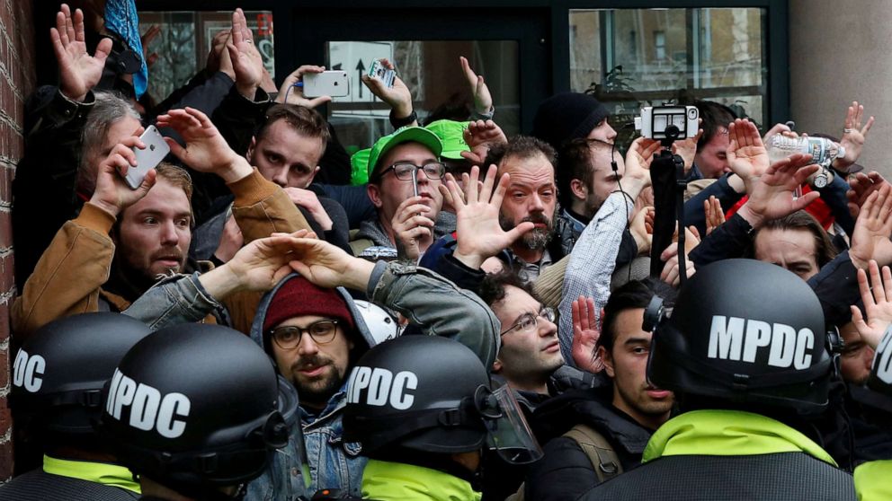 PHOTO: Protesters demonstrating against President Donald Trump raise their hands as they are surrounded by police on the sidelines of the inauguration in Washington, D.C, Jan. 20, 2017.