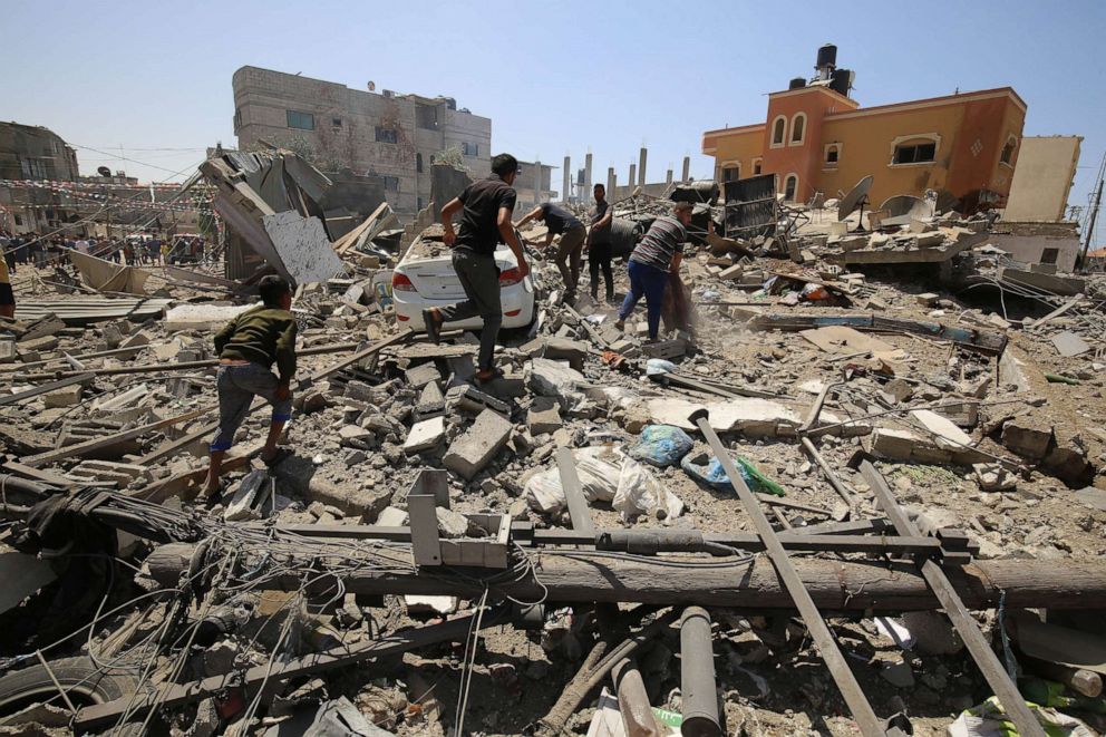 PHOTO: Palestinians gather following an Israeli airstrike in Rafah in the southern Gaza Strip on May 20, 2021.