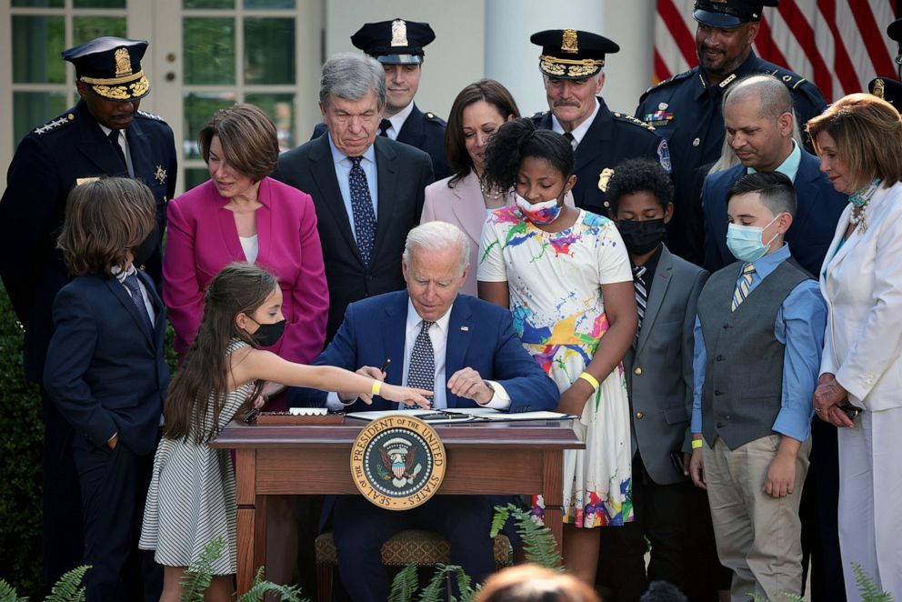 PHOTO: President Joe Biden, joined by lawmakers and members of law enforcement and their families, signs legislation to award congressional gold medals to law enforcement in the Rose Garden of the White House on Aug. 5, 2021.