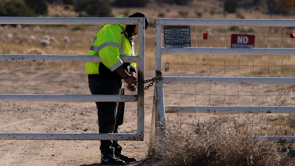 PHOTO: A security guard manning the entrance to the Bonanza Creek Ranch film set locks the gate after turning away workers who came to pick up equipment in Santa Fe, N.M., Oct. 25, 2021.