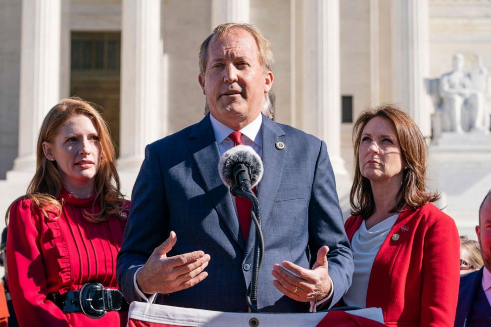 PHOTO: Texas State Rep. Shelby Slawson, left, and Texas State Sen. Angela Paxton, right, listen as Texas Attorney General Ken Paxton, center, speaks to anti-abortion activists at a rally outside the Supreme Court, Nov. 1, 2021, in Washington.