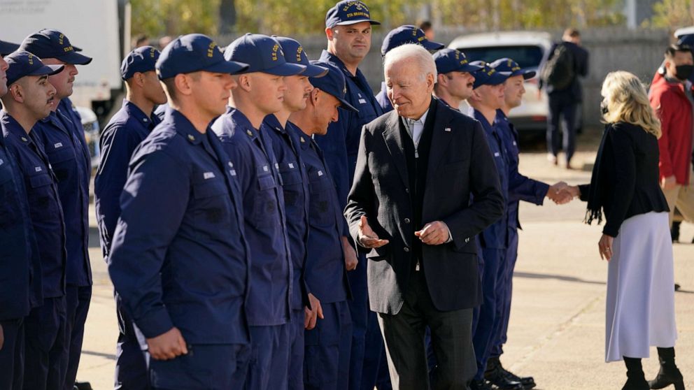 PHOTO: President Joe Biden hands out challenge coins as he and first lady Jill Biden meet with members of the Coast Guard at the United States Coast Guard Station Brant Point in Nantucket, Mass., Nov. 25, 2021.