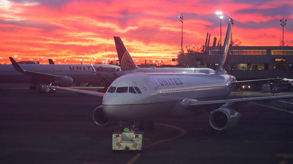 PHOTO: A United Airlines airplane is pushed back from its gate at Newark Liberty International Airport as the sun rises in Newark, N.J., Dec. 13, 2021.