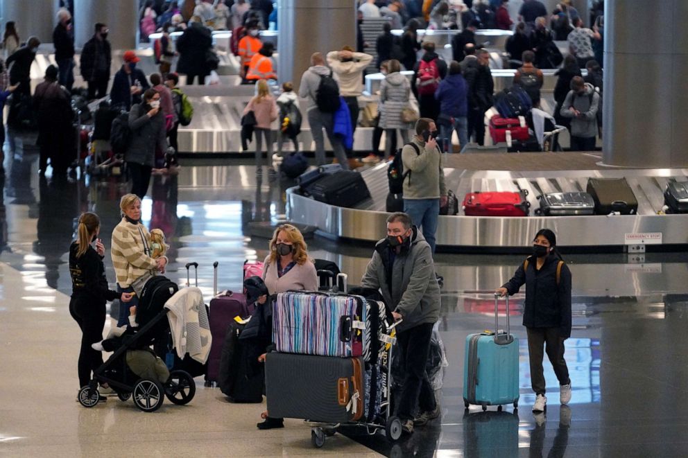 PHOTO: Travelers pass through Salt Lake City International Airport, Dec. 27, 2021, in Salt Lake City.