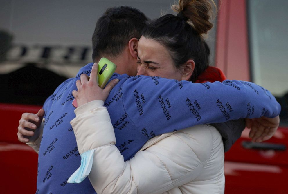 PHOTO: Aysel, 33, from Kherson, Ukraine, hugs her husband, amid Russia's invasion of Ukraine, as they meet at the border crossing in Medyka, Poland, March 23, 2022.