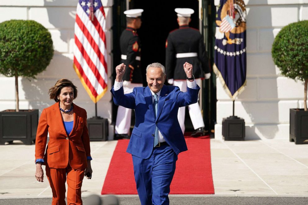 PHOTO: House Speaker Nancy Pelosi and Senate Majority Leader Chuck Schumer arrive for a celebration of the enactment of the 