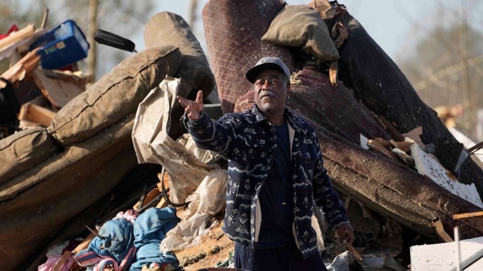 PHOTO: A resident looks through the piles of debris, insulation, and home furnishings to see if anything is salvageable at a mobile home park in Rolling Fork, Miss., Saturday, Mar. 25, 2023.